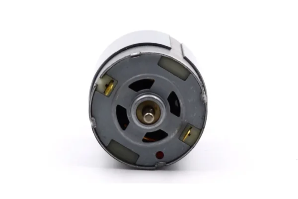 Rear housing cap of an electric vibrating motor with low-resistance solder tabs