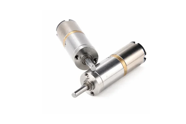 high torque micro planetary gear motor structure Top-down angle view of two micro planetary geared electric motors showing the mounting holes on the front faceplate and the dual ball-bearing output shaft