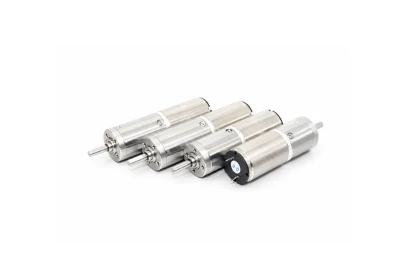 micro dc planetary gear motors tsl pg16 Four 16mm micro DC planetary gear motors lined up showing the dual ball-bearing output shafts and rear electrical terminals