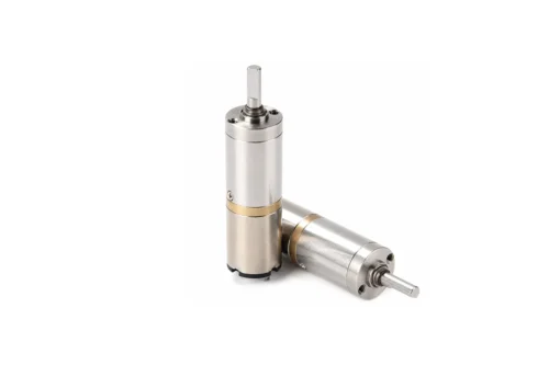 A 12V micro planetary geared electric motor standing vertically alongside another lying down, showcasing the coreless brushed DC motor design and D-cut output shaft