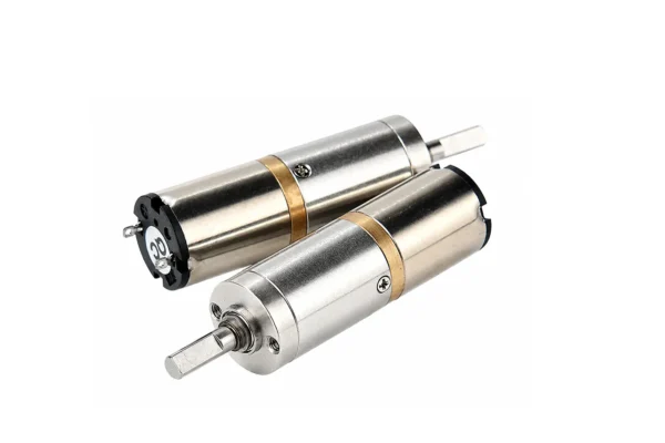 micro planetary geared electric motor terminals Rear and front view of a micro planetary geared electric motor, showing the positive/negative solder terminals with a QC pass sticker and the D-shaped shaft