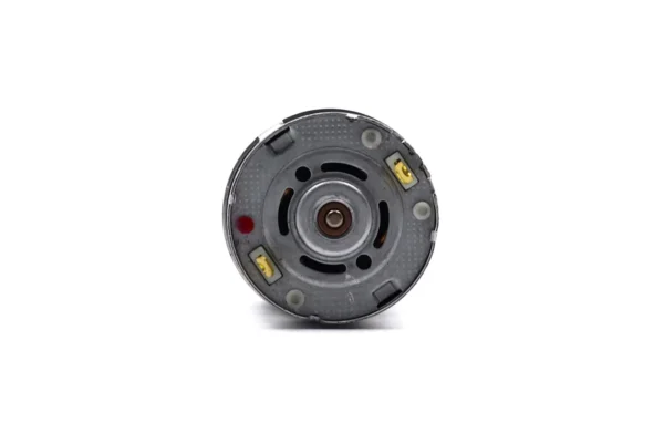 Rear end cap view of 555 brushed DC motor showing terminal posts and polarity indicator